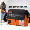 Orange and black waterproof nylon crossbody bag shown with multiple similar bags in the background.