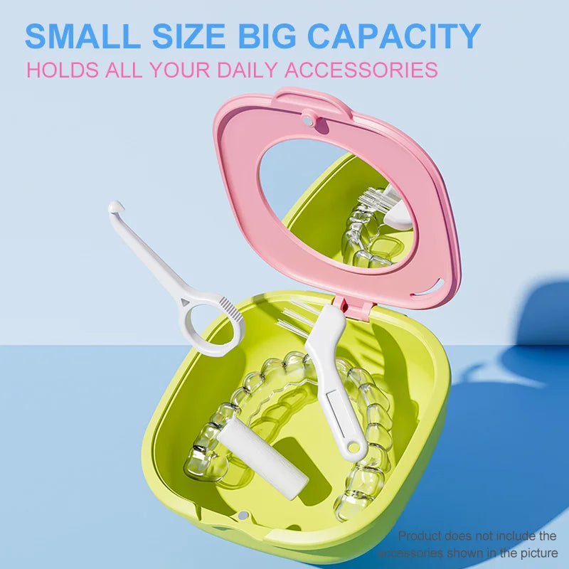 A pink denture storage box with a mirror is open, showing a white denture and a pair of pliers inside.