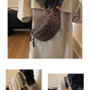 A beige top model is shown wearing a leopard print crossbody bag with an adjustable strap.