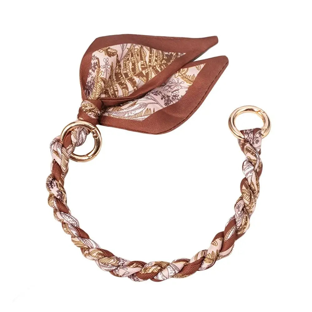 Brauner Seidenschal-Taschenketten mit gemustertem Stoff und goldfarbenen Schnallen.