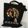 Black canvas tote bag featuring a tree made of books with a cat silhouette and butterfly details.