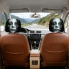 A set of spooky ghost face car headrest covers on a vehicle interior.