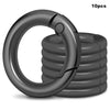 A stack of ten black metal key ring clips with spring-loaded fasteners.