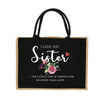 Schwarze Jute-Tasche mit weißem gesticktem Text „I love you sister“ und rosa Blumenmuster