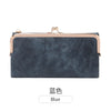 Dunkelblaue Lederclutch mit goldfarbenem Verschluss gegen weißen Hintergrund.
