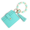 A teal silicone bead and leather card wallet with a gold-toned chain and tassel.
