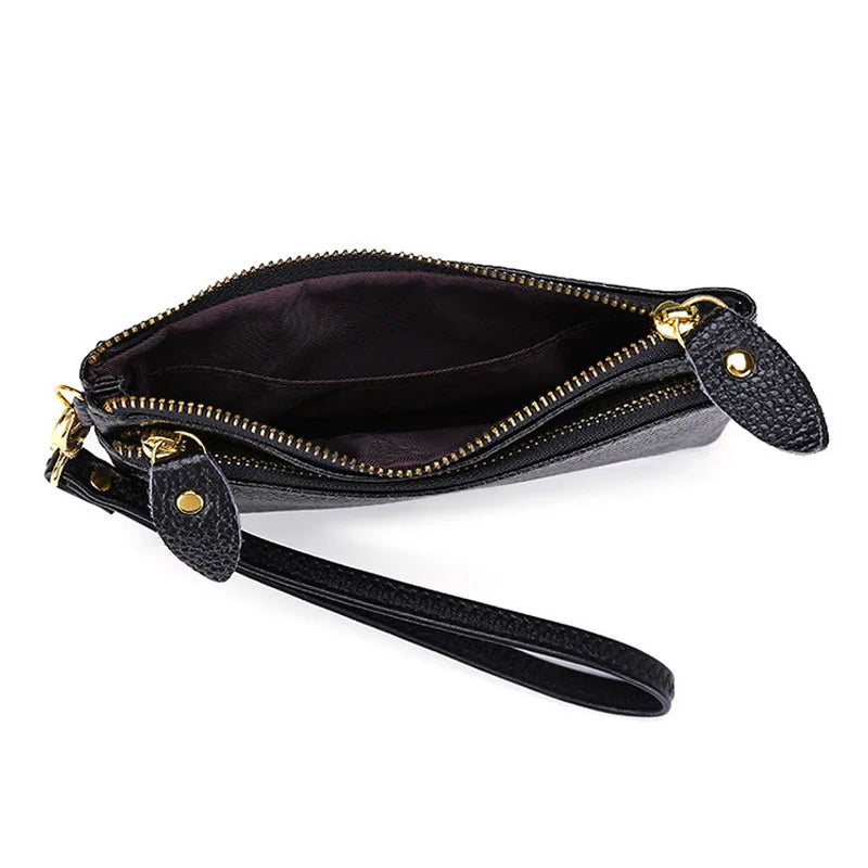 Black genuine leather wristlet clutch wallet with a zipper closure and leather strap