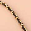 A close-up of a gold and black leather chain strap for an adjustable crossbody purse.