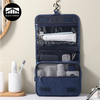 A dark blue portable waterproof toiletry washbag with a hanging hook, showing various toiletries inside.