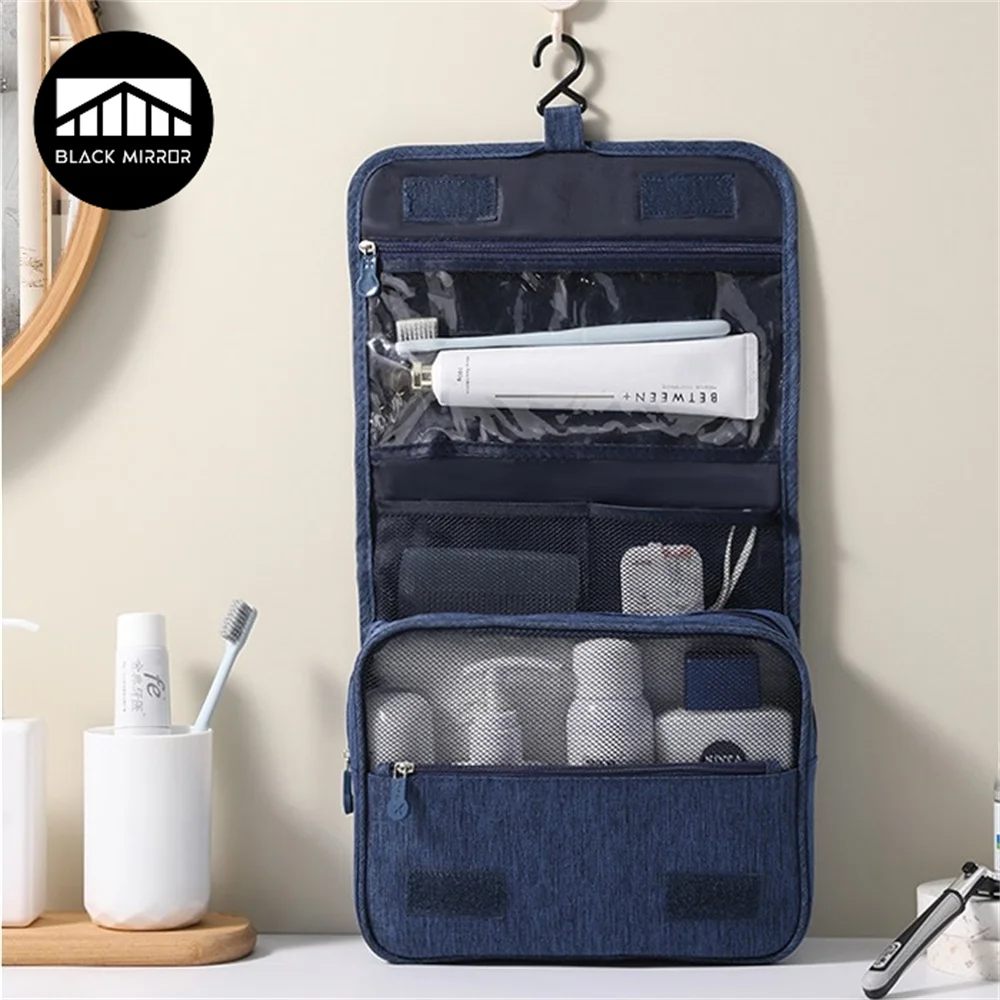 A dark blue portable waterproof toiletry washbag with a hanging hook, showing various toiletries inside.