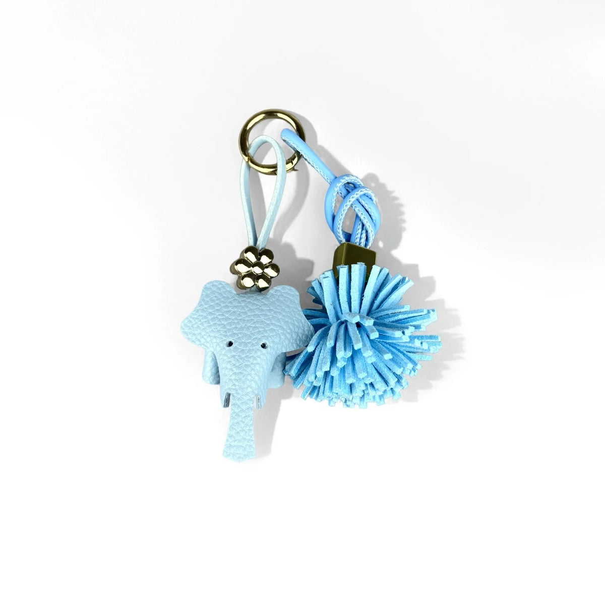A set of blue floral PU leather keychain and bag charm featuring a elephant shape and a pom-pom tassel.