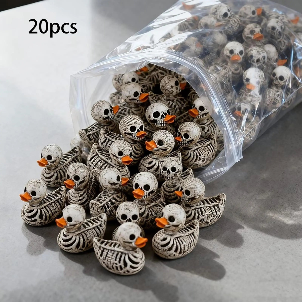 A pile of 20 gothic skull duck figurines in a clear plastic bag