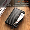 A black carbon fiber wallet with a zipper is shown resting on a wooden surface.