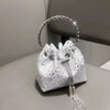A silver-rimmed clutch bag covered in sparkling crystals and embellished with a dangling chain.