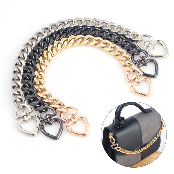 A curved display of heart-shaped metal chains in silver, black, and gold.