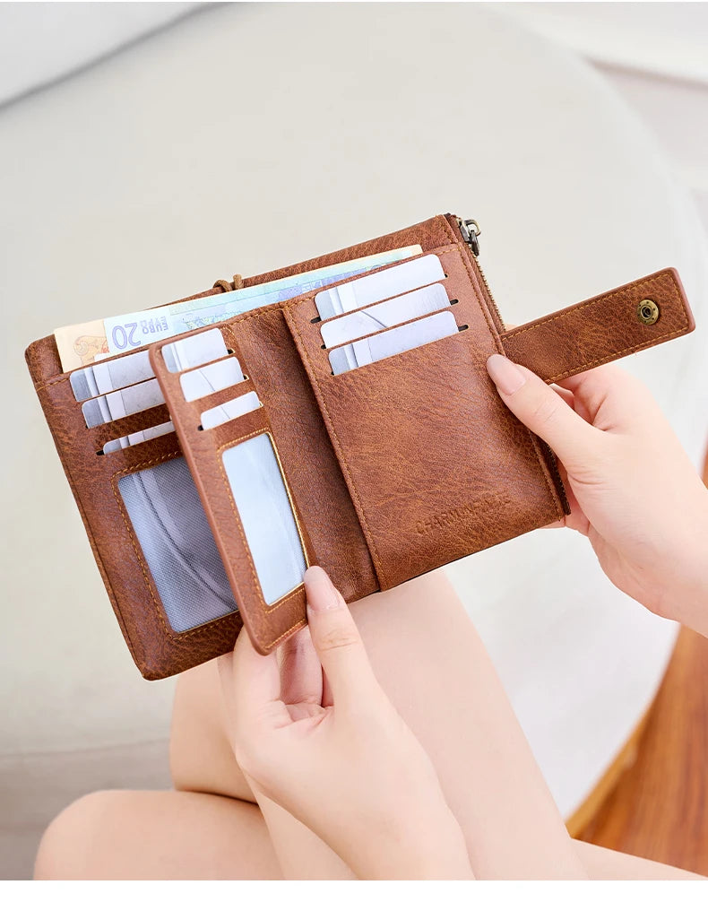 A brown leather multi-slot wallet with multiple cards is held by a person.