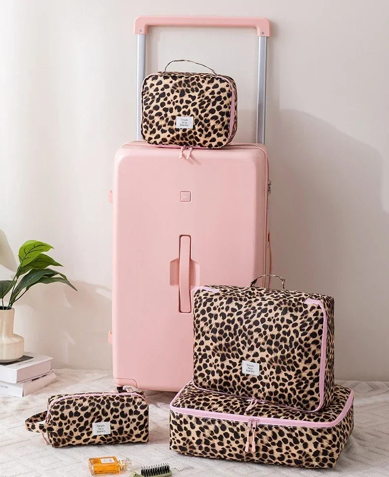 A pink large capacity waterproof travel makeup organizer bag with a leopard print exterior and matching case.
