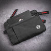 Black RFID blocking travel wallet with a carabiner clip resting on a gray background.