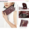 A close-up of a dark burgundy leather clutch wallet showing different features like a double buckle, RFID blocking, and a zip