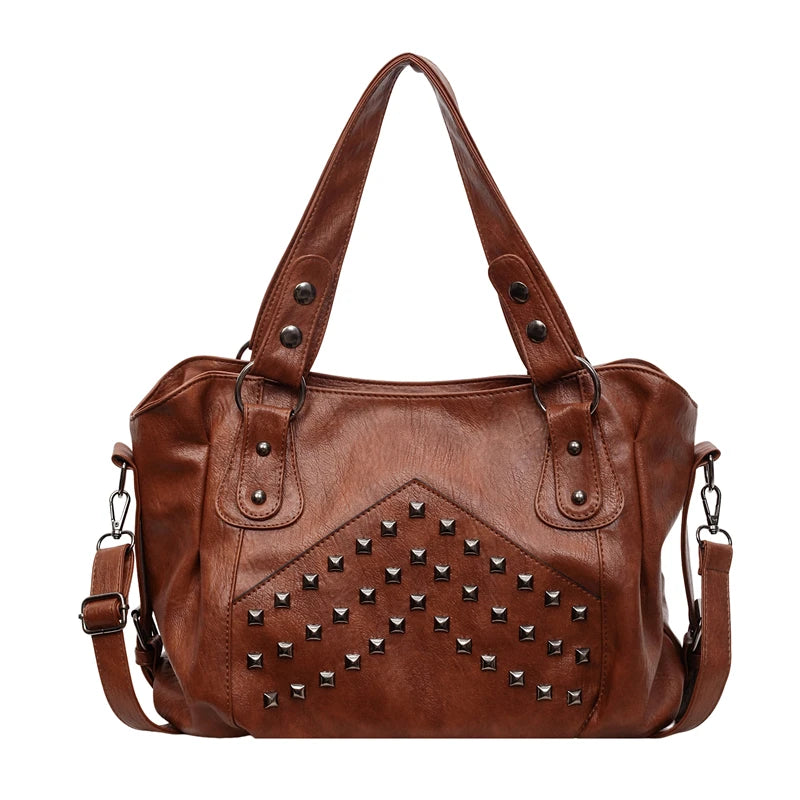 A brown leather tote bag featuring a studded design with metal rivets and straps.