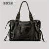 A black vintage washed leather tote bag with gold hardware shown against a light gray background.