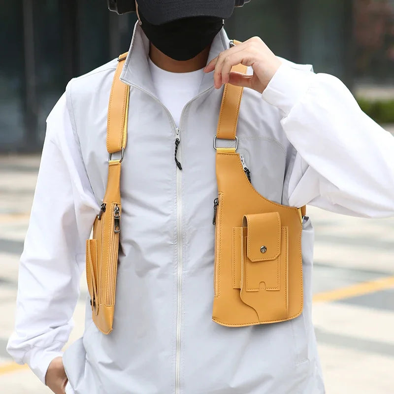 A person wearing a white shirt and black bandana is holding a tan tactical chest bag with multiple pockets.