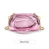 A small pink glossy clutch bag with gold metal hardware.