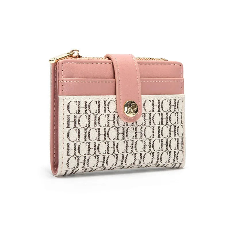 A pink and cream patterned square folding wallet with gold hardware.