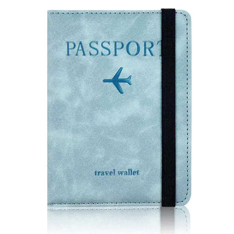 A light blue leather passport holder with a dark strap and the word passport printed on it.