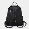 A black waterproof women's travel backpack shown from the back.