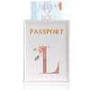 A pink leather passport holder with a gold embossed letter L and a small rose design.