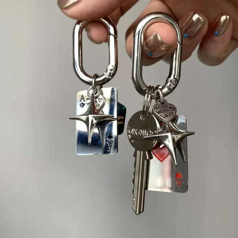 Silver keychain set featuring a key and a rectangular resin charm with a star design