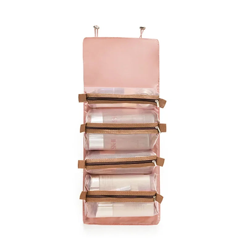 A pink portable detachable makeup bag with multiple zippered compartments for travel.