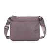 A mauve waterproof nylon crossbody bag with a flap and strap is shown against a white background.
