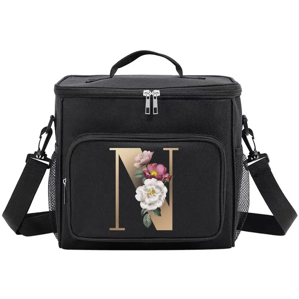 Black insulated canvas lunch bag with dual handles featuring a gold initial N and floral accents.