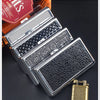 A silver metal cigarette case holder with textured surfaces is shown next to a box of tobacco.