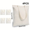 Quatre sacs en toile de coton blanc avec poignées beige clair, présentés verticalement.