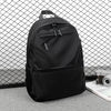 A black men's lightweight laptop backpack is shown against a wire mesh background.
