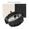 Black quilted mommy bag with a crossbody strap showing interior organization and waterproof fabric details.