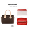 A brown leather inner bag with a beige shoulder strap and separate red lining visible.
