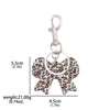 Silver keychain featuring a leopard print bow and heart charm.