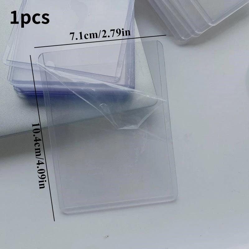 A clear acrylic photocard holder with a wing design is shown next to a purple plastic case.