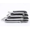 A set of four vertical travel organizer bags in black and gray fabric with adjustable straps.