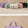 A purple nylon travel duffle bag with an argyle pattern is shown in a studio setting.