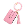 Pink leather card holder with a gold chain and pink beaded bangle keychain