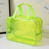 A clear, lime green waterproof makeup organizer bag with a handle is displayed on a white surface.