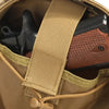 A tactical sling bag in tan canvas holds a black handgun and a brown leather holster.