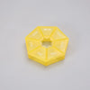 A yellow, hexagonal pill organizer divided into seven sections labeled with the days of the week.
