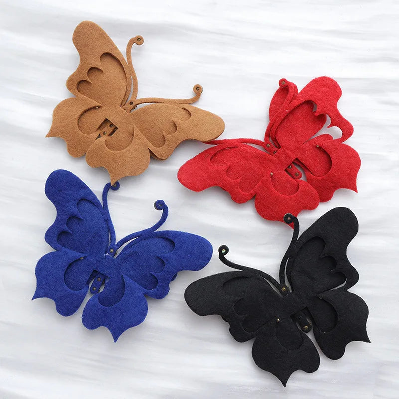 Four decorative butterfly appliqués in brown, red, blue, and black fabric.