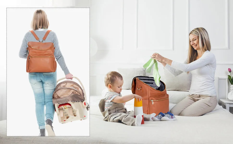 A woman wears a brown backpack diaper bag while sitting on a bed with a baby nearby.